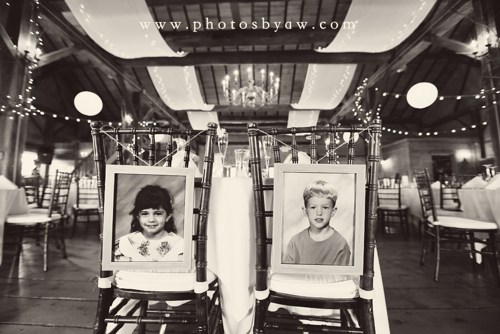 bride_and_groom_childhood_photos_on_backs_of_their_chairs